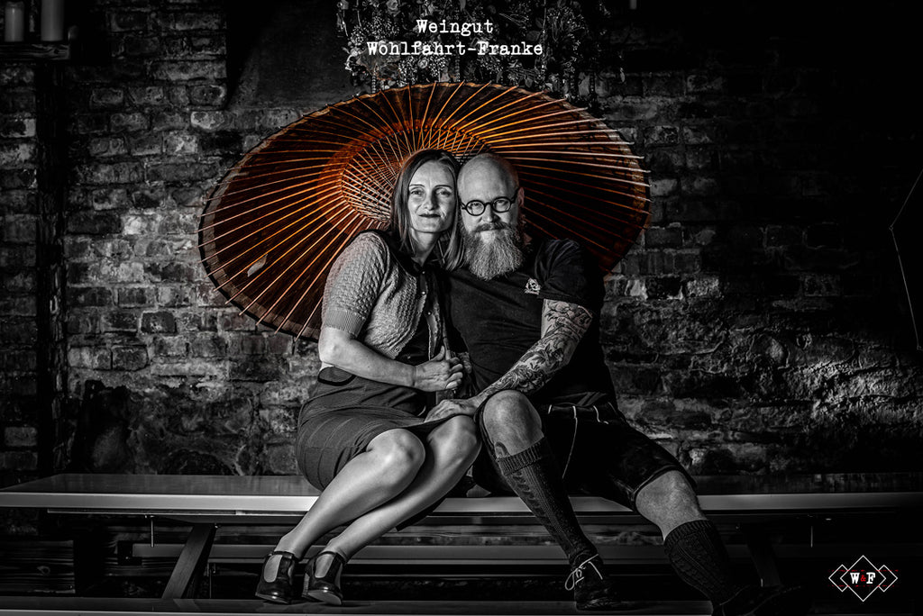 Weingut Wohlfahrt-Franke - Winzer Paar unter Sonnenschirm im Weinkeller