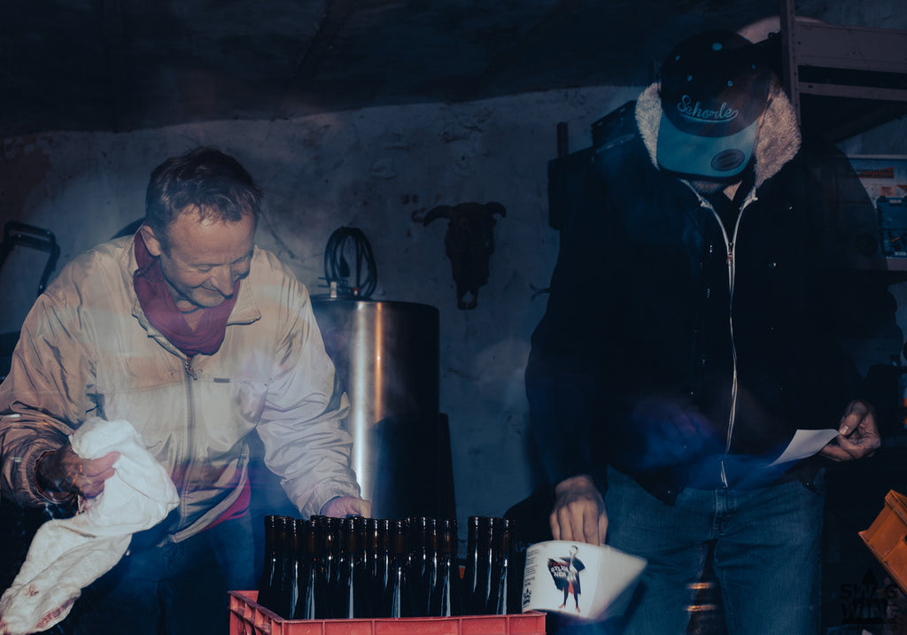 Winzer Andreas Durst und Sven von Swagwine kleben die Transsylvaner Etiketten auf Weinflaschen